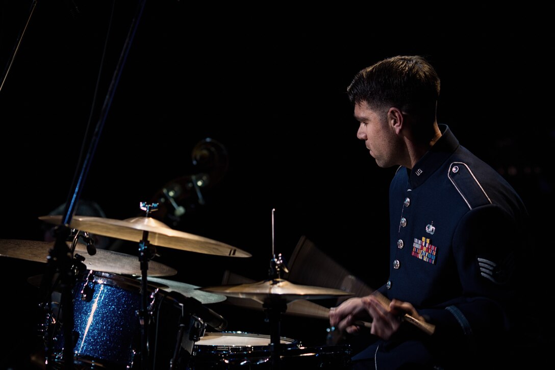 HAMURA CITY, Japan -- Staff Sgt. Steve Helfand, Band of the Pacific-Asia drummer, concentrates on the rhythm during the Japan-U.S. Joint Concert at the Yutorogi Learning Center, Hamura City, Japan, Jan. 28, 2012. Helfand routinely practices 20 hours per week on drums to improve his playing. (U.S. Air Force photo/Staff Sgt. Josh Voyles)