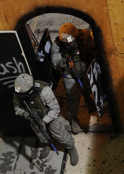 MINOT AIR FORCE BASE, N.D. – Security forces members simulate clearing a room here, Jan 18. Five individuals participated in the 91st Missile Security Squadron Tactical Response Force tryouts. The tryouts consisted of running, push-ups, sit-ups, and tactical maneuvers. (U.S. Air Force photo/Senior Airman Ashley N. Avecilla)