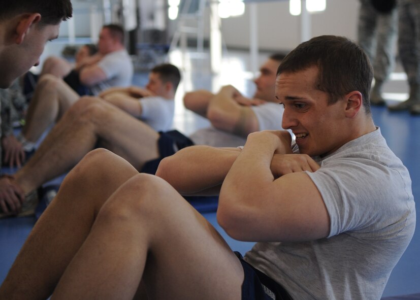 MINOT AIR FORCE BASE, N.D. – Airman 1st Class Ryan Watson, 791st Missile Security Forces Squadron response force leader, performs a sit-up here, Jan 18. Five individuals participated in the 91st Missile Security Squadron Tactical Response Force tryouts. The tryouts consisted of running, push-ups, sit-ups, and tactical maneuvers. (U.S. Air Force photo/Senior Airman Ashley N. Avecilla)
