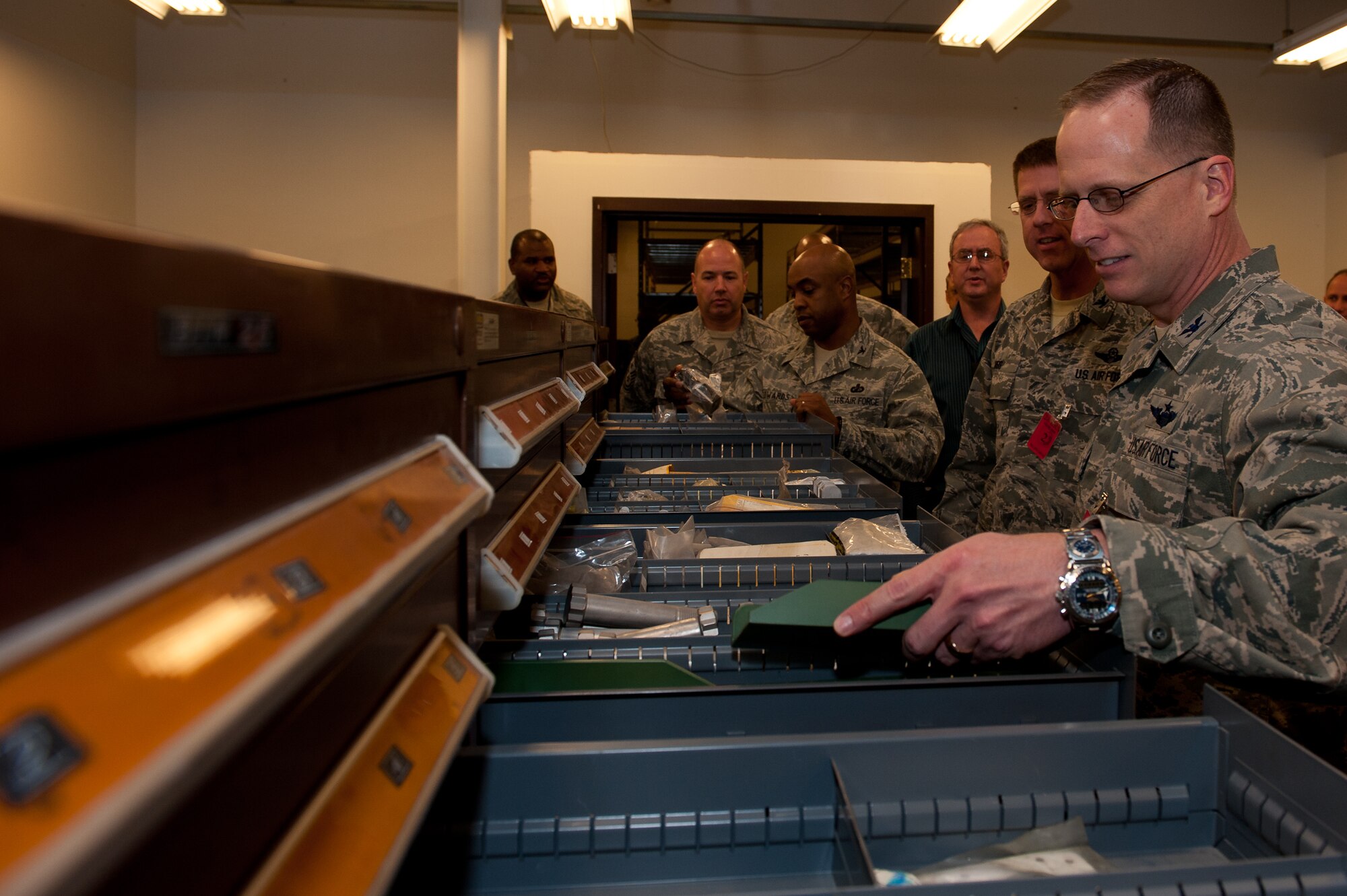 Leaders of the 28th Bomb Wing look through drawers of B-1B parts during a visit to Al’s Garage at Ellsworth Air Force Base, S.D., Jan. 26, 2012. Al’s Garage is a storage warehouse that was transformed into a well-stocked and organized storage facility of B-1B parts. (U.S. Air Force photo by Airman 1st Class Kate Thornton/Released)