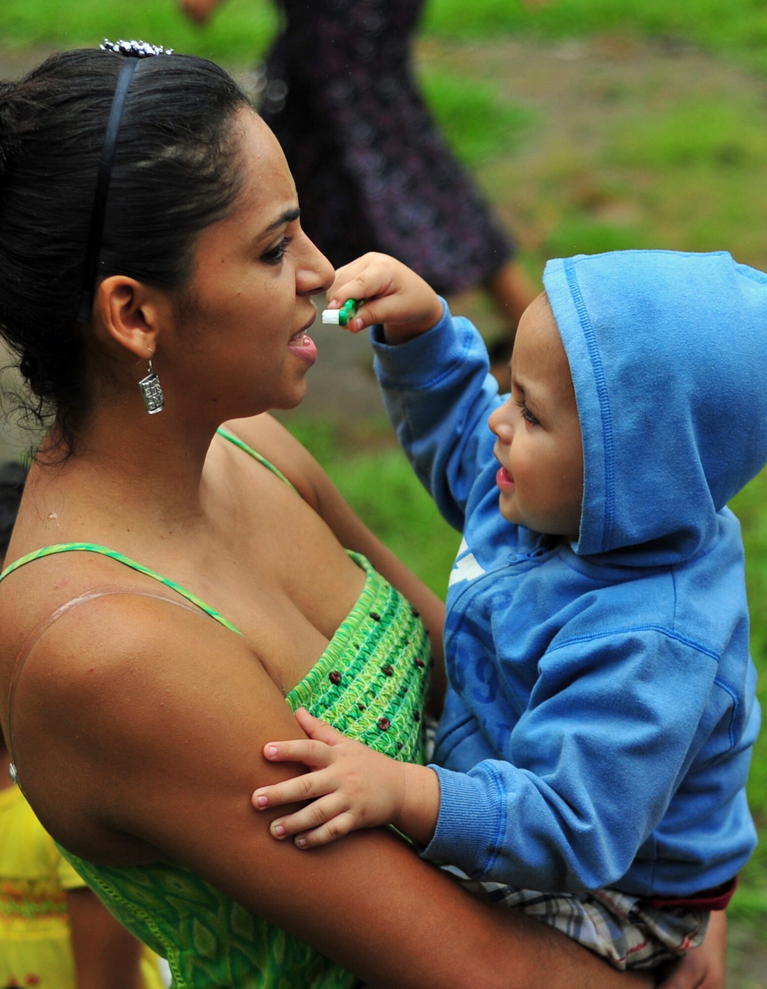 OLANCHO, Honduras – A mother and son practice brushing teeth as they wait for a dental checkup during the Joint Medical Readiness Training Exercise Jan. 31 here. Dental hygiene and diet play the biggest factors in dental health, which are taught during the preventive health portion of the joint MEDRETE. (Air Force photo/Staff Sgt. Bryan Franks)
