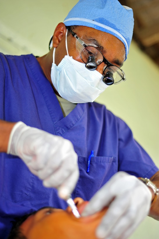 OLANCHO, Honduras – Lt. Col. Ray Williams, Medical Element dentist, extracts an adult molar from a La Bacadia community member during the Joint Medical Readiness Training Exercise with members from the Honduran Ministry of Health, the Honduran military and Joint Task Force-Bravo, Soto Cano Air Base, Honduras Jan. 31 here. MEDRETES enhance the medical readiness training of U.S. forces as well as provide sustained health benefits to the population. (Air Force photo/Staff Sgt. Bryan Franks) 
