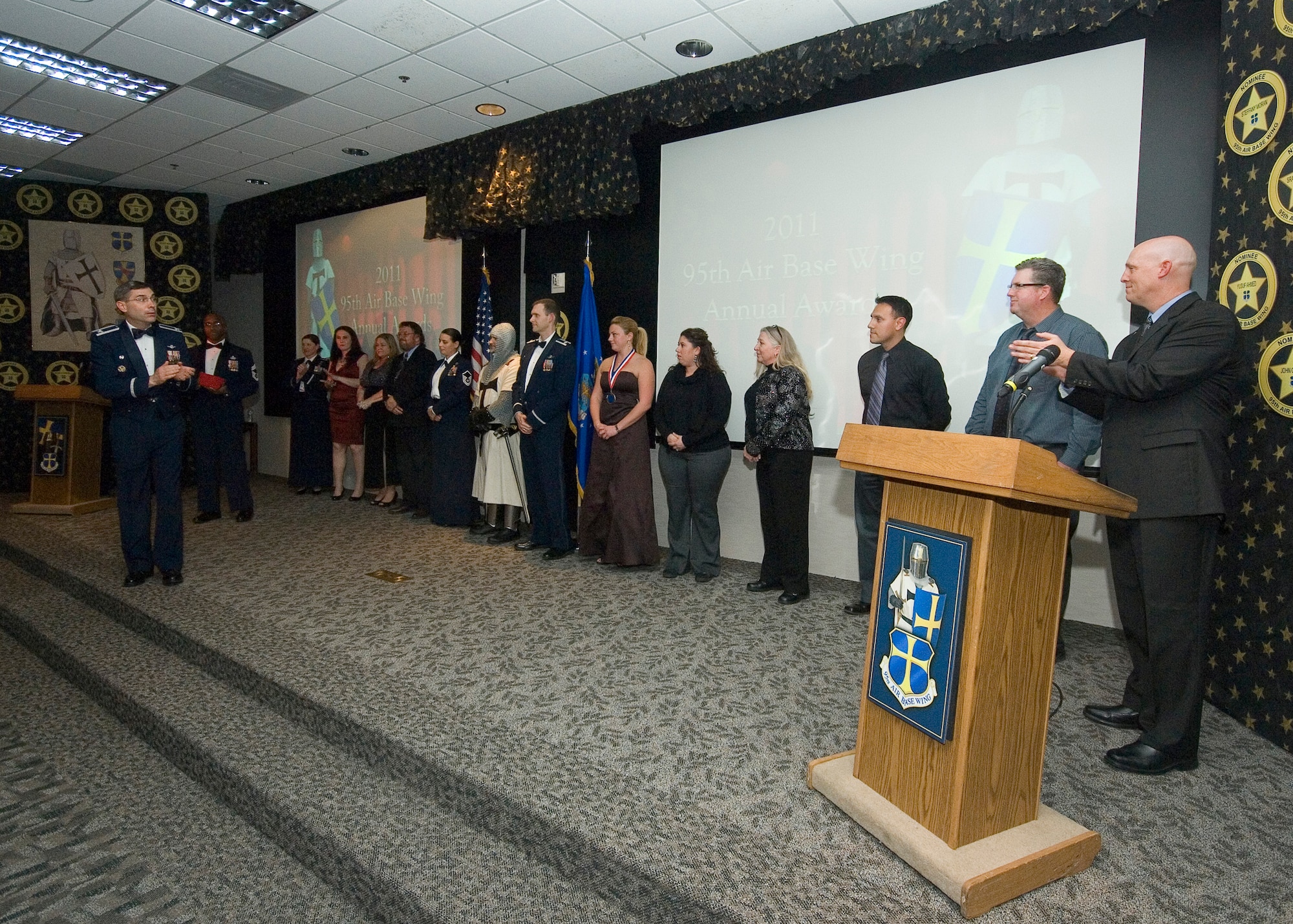 Col. Gregory E. Schwab, left, 95th Air Base Wing commander, thanks workers from several offices who helped make possible the 95th Air Base Wing Annual Awards Ceremony Jan. 27. (U.S. Air Force photo by Rob Densmore)