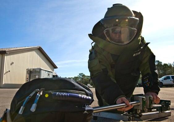 Staff Sgt. Travis Groeschel, an Explosive Ordnance Disposal technician with the 96th Civil Engineer Group, moves an extendable arm toward a simulated suspicious package during a demonstration at Eglin Air Force Base, Fla.  The EOD flight is responsible for many of the range missions involving explosives.  They also respond to suspicious packages or recovered unexploded ordnance found in the area.  (U.S. Air Force photo/Samuel King Jr.)