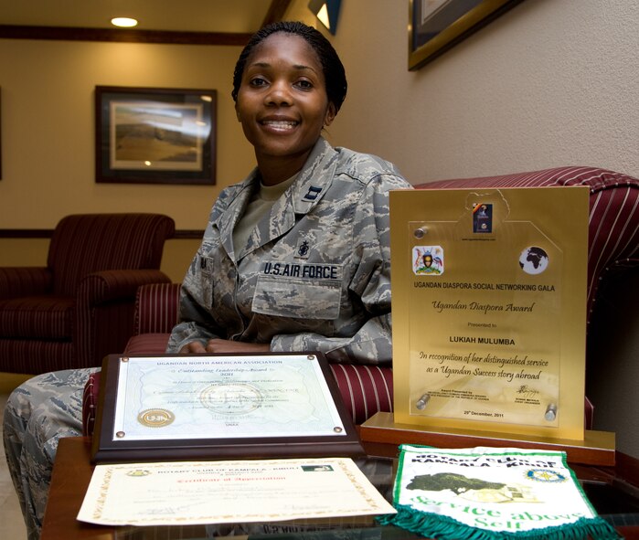 Capt. Lukiah  Mulumba, 60th Inpatient Squadron, sits by her awards she achieved in Uganda for her work with children who have sickle cell disease Jan. 18. (U.S. Air Force photo/Airman 1st Class Nicole Leidholm)