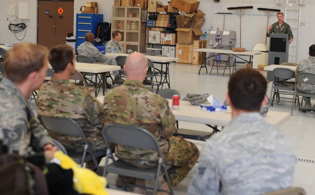 Col. Jeffrey L. Macrander, commander of the 920th Rescue Wing, addresses 943rd Rescue Group deployers and theirs families during his first visit to the rescue group as wing commander. (U.S. Air Force Photos/ Airman 1st Class Christine Griffiths) 