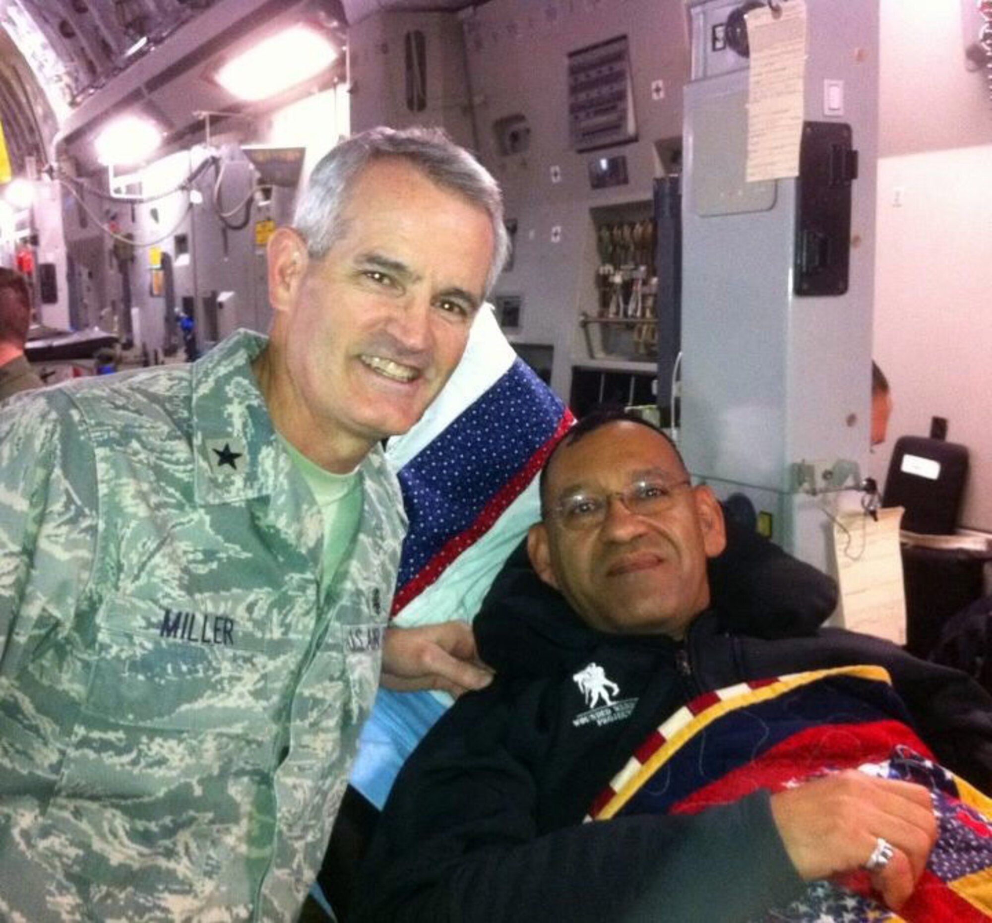 Maj. George Zaldivar (right) is greeted by Brig. Gen. Michael Miller, the chief of the Medical Service Corps, Office of the Surgeon General, on his way home to the U.S. from Kandahar Airfield, Afghanistan, in October 2011. Zaldivar suffered a traumatic brain injury when a rocket struck just outside the medical facility in which he worked in Afghanistan. (Couresty photo/Maj. George Zaldivar) 