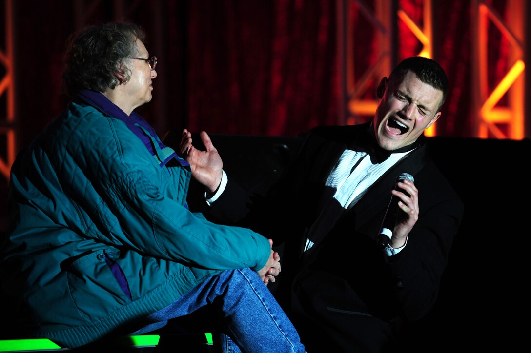 U.S. Air Force 1st Lt. Robert Doyle, Tops In Blue officer in charge and vocalist, sings to an audience member during a performance at the Hampton Convention Center in Hampton, Va., Jan. 2, 2012.  This year's show featured American music from the early 1900s to present day, providing a glimpse of a century of popular music and illustrating its growth through new rhythms and technology.  (U.S. Air Force photo by Airman 1st Class Kayla Newman/Released)