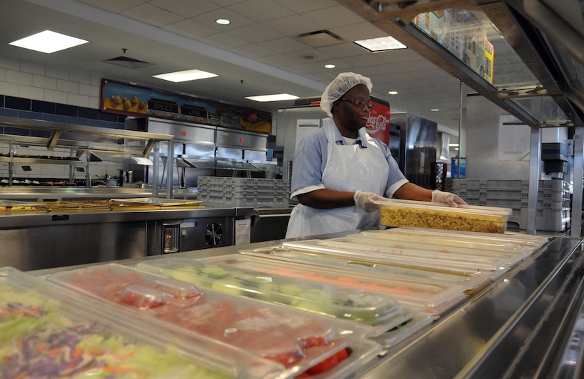 Barbara Pinckney prepares the salad bar prior to the lunch hour at the Rainbow Row Galley at Joint Base Charleston-Weapons Station, Jan. 25. More than 140 Goodwill employees, hired through the AbilityOne program, contribute to the overall success of the five-star rated dining facility by prepping, cooking, cleaning and serving food to service members. The AbilityOne program is a federal initiative that helps people who are blind or have other significant disabilities find employment by working within a national nonprofit agency that sell products and services to the U.S. government. (U.S. Navy photo/Petty Officer 1st Class Jennifer Hudson)