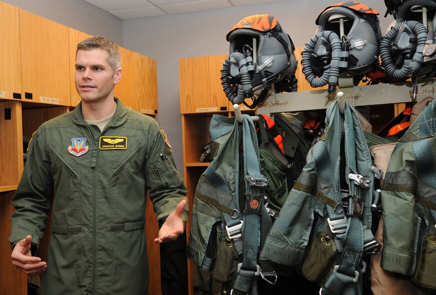 Capt. Jonathan Barber, assigned to the 391st Fighter Squadron, Mountain Home Air Force Base, Idaho, explains the equipment pilots use during an interview with local media on Barksdale Air Force Base, La., Jan. 25. Life support equipment includes a variety of items such as a helmet, oxygen mask and G-suits which keep pilots from passing out during extreme maneuvers. (U.S. Air Force photo/Airman 1st Class Andrew Moua)(RELEASED)