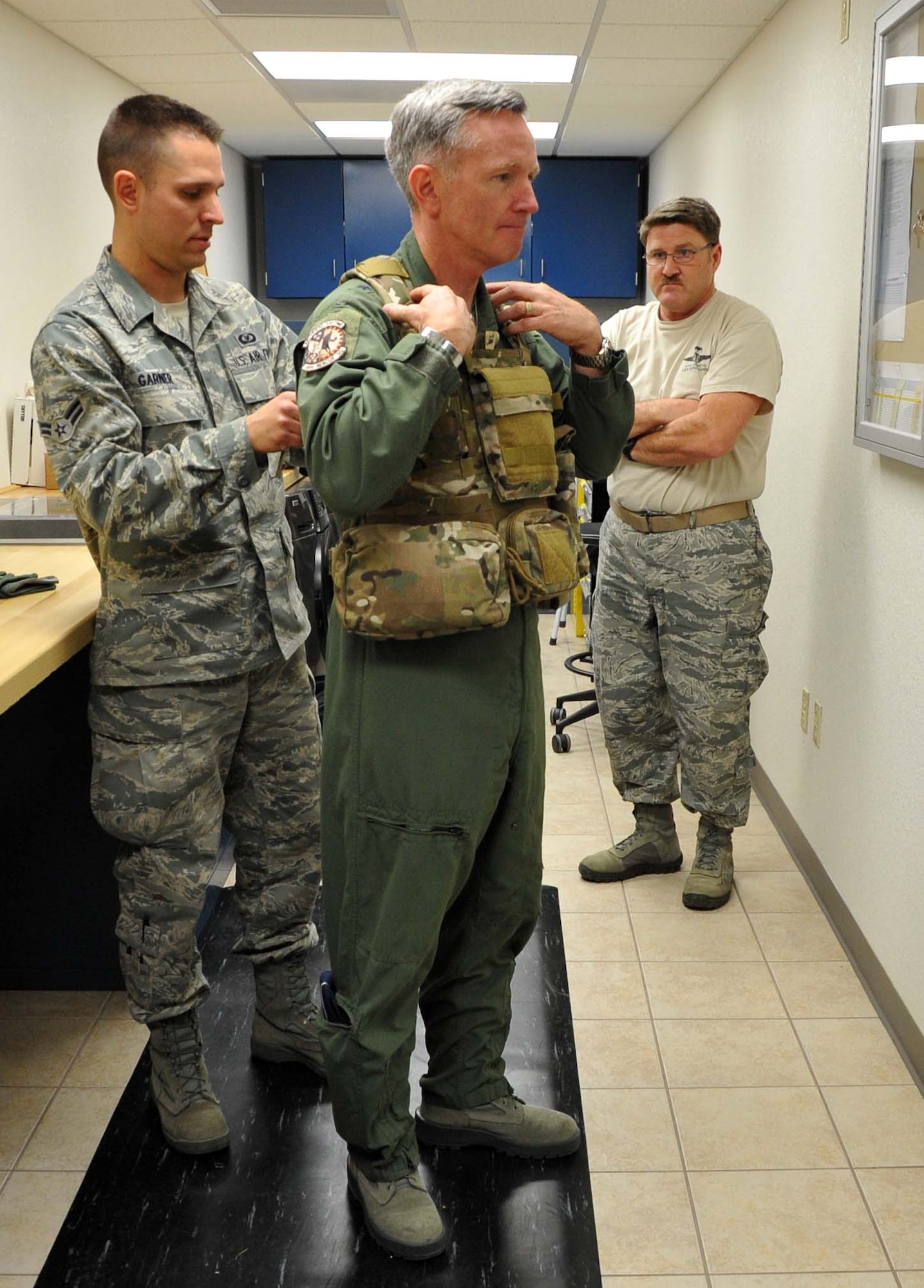 Airman Scott Garner with the 943rd Operations Support Flight fits Brig. Gen. William Binger's flight gear prior to the general's flight in an HH-60 Pave Hawk helicopter. The general visited the 943rd Rescue Group to learn about its combat-search-and-rescue mission and visit with Reserve Airmen stationed at Davis Monthan Air Force Base, Ariz. (U.S. Air Force Photo/ Master Sgt. Luke Johnson)
