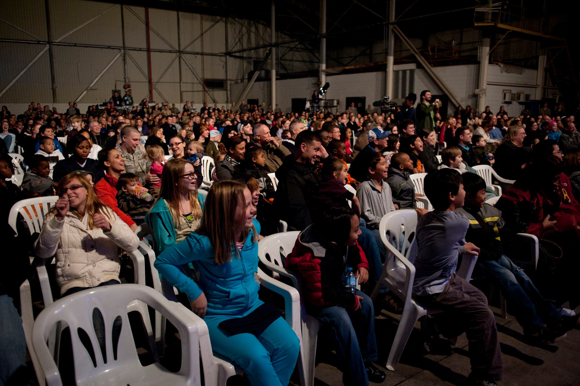 Audience members cheer during a Cirque Dreams World Tour performance Jan. 30, 2012, at Incirlik Air Base, Turkey. Cirque Dreams partnered with Armed Forces Entertainment to perform "Jungle Fantasy" at 17 military installations in 10 different countries through Asia and Europe. (U.S. Air Force photo by Tech. Sgt. Michael B. Keller/Released)