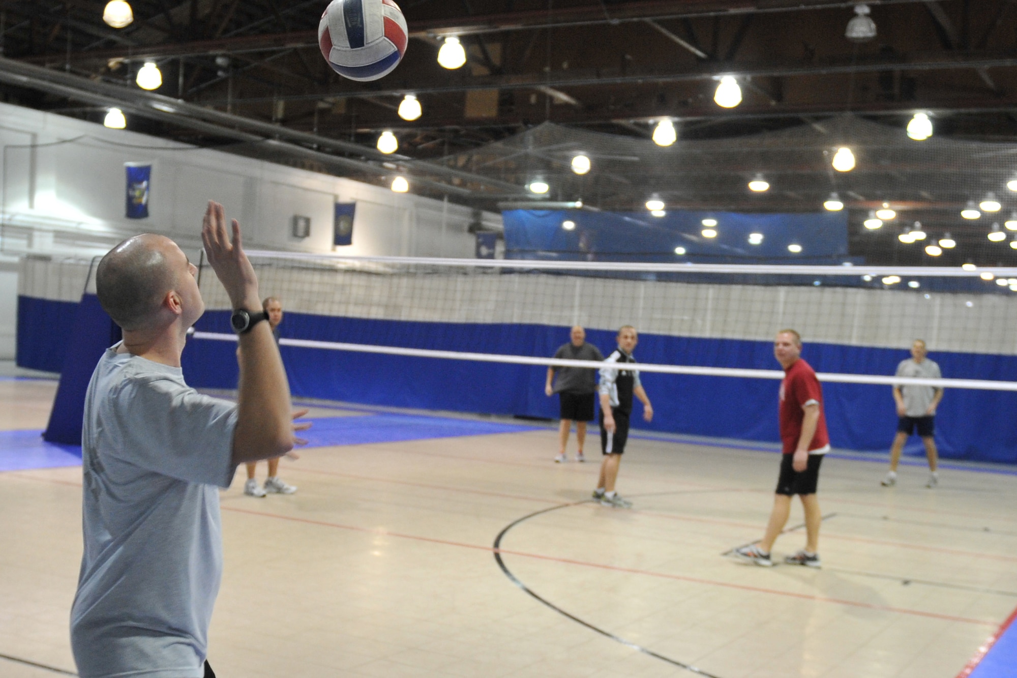 Tech. Sgt. Brian Kluball from the defense courier station, serves the ball for his volleyball team as part of Resilience Day on Offutt Air Force Base, Neb., Jan. 27. Team Offutt members took part in various activities throughout the base including sporting events at the Offutt Field House. The chief of staff of the Air Force directed a stand down to operations for a day to discuss resilience and the wingman concept. (Air Force photo by Jeff Gates/Released)