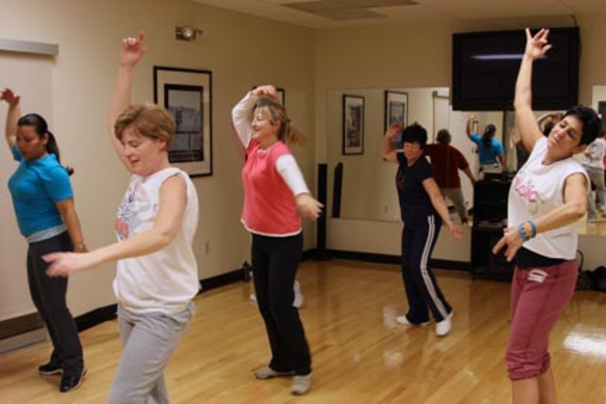 Patty Renziehauzen, right, a fitness instructor from Pittsburgh, instructs a Zumba class at the 911th Airlift Wing Fitness Center, Jan. 30, 2011. Numerous fitness classes are given daily at the center, ranging from volleyball tournaments to spin endurance classes. Please get in touch with Tamra Davis, the facility manager, and inquire about the unlimited ways to increase your physical health. (U.S. Air Force Photo by Tech. Sgt. Ralph Van Houtem/Released)