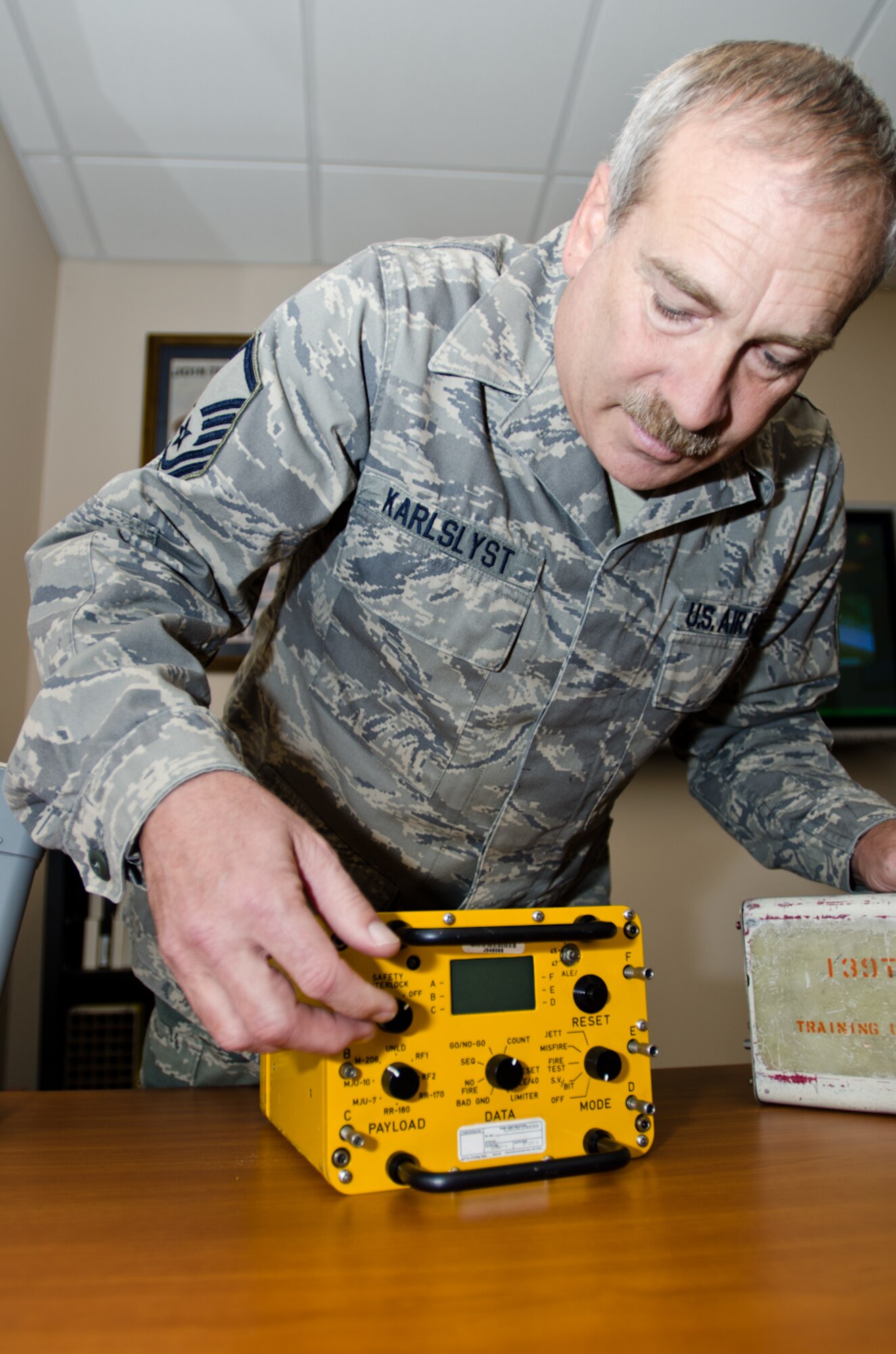 Master Sgt. Rick Rick Karlslyst, defensive systems instructor for the Advanced Airlift Tactics Training Center, turns on a chaff flare tester at Rosecrans Air National Guard Base, St. Joseph, Mo., Jan. 31, 2012. Karlslyst teaches aircraft maintenance Airmen how to properly handle and load chaff flares for various types of aircraft. (Missouri Air National Guard photo by Staff Sgt. Michael Crane)