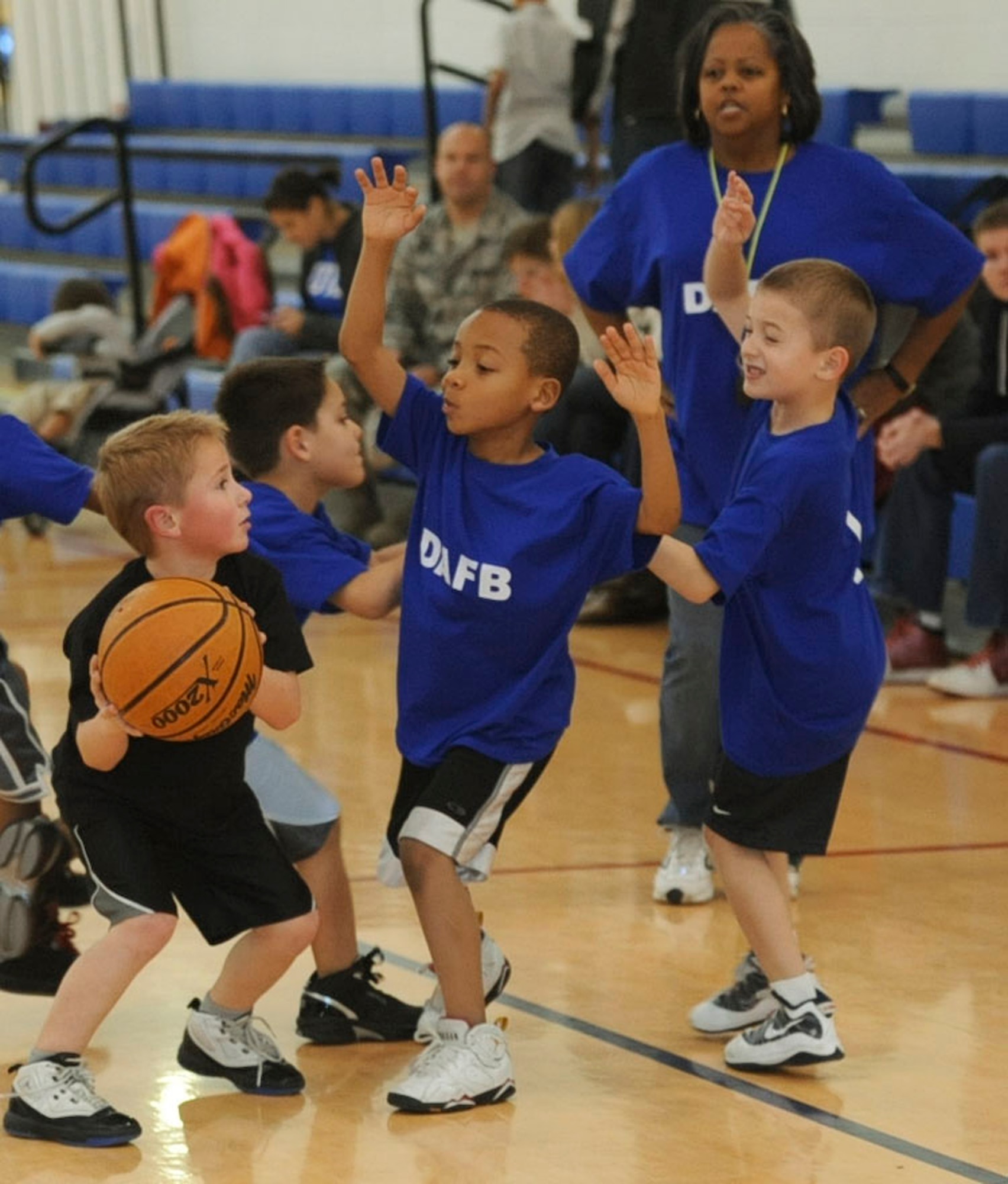 Children at the Youth Center play a basketball game Jan. 27, 2012, at the Dover Air Force Base, Del., Youth Center. The game is a chance for the kids to get up and move around, helping to establish a firm foundation for their future physical fitness. (U.S. Air Force photo by Senior Airman Matthew Hubby)