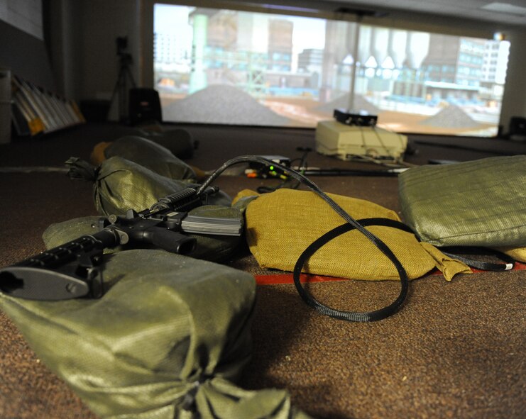 An M-4 carbine rifle connected to a training simulator rests on sandbags at Barksdale Air Force Base, La., Jan. 30. Training weapons connected to the computer use sensors to track where the user is aiming and uses carbon dioxide to simulate the weapon firing and recoiling. (U.S. Air Force photo/Airman 1st Class Micaiah Anthony)(RELEASED)