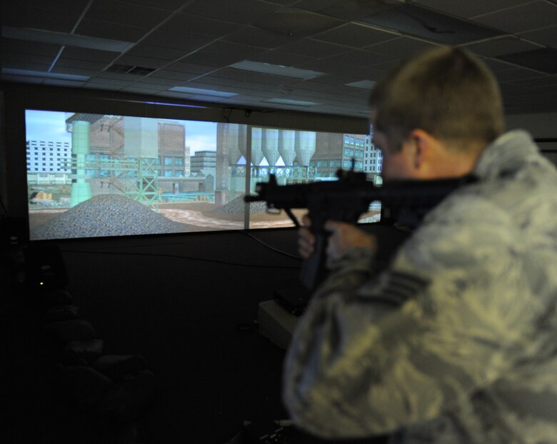 Staff Sgt. Nicholas Niles, 2nd Security Forces Squadron combat arms instructor, looks though the site of an M-4 carbine rifle during a combat training simulation at Barksdale Air Force Base, La., Jan. 30. The simulator gives users several different scenarios in which deadly force may or may not be required. (U.S. Air Force photo/Airman 1st Class Micaiah Anthony)(RELEASED) 
