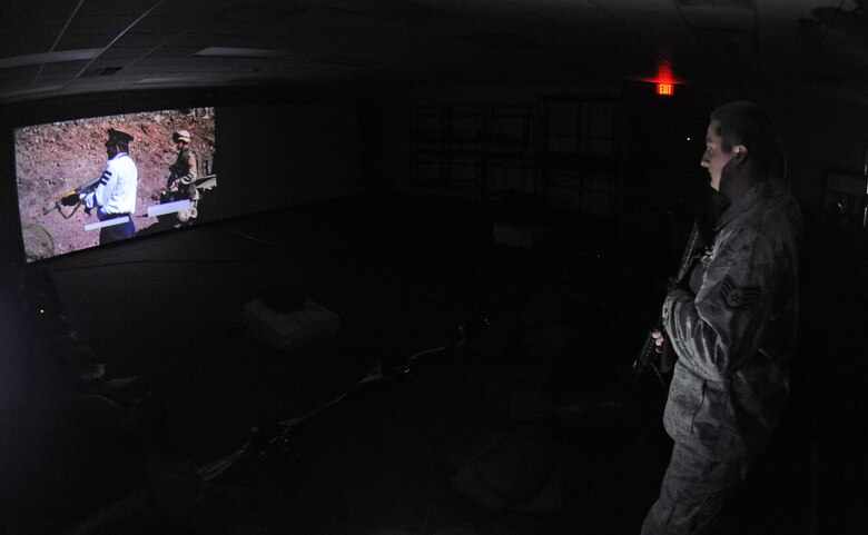 Staff Sgt. Nicholas Niles, 2nd Security Forces Squadron combat arms instructor, listens to a pre-mission brief for a combat training simulator at Barksdale Air Force Base, La., Jan. 30. The combat simulator is capable of supporting various weapon systems such as the M-9 Beretta, M-4 carbine rifle, M-16A2 rifle and the M-249B light machine gun. (U.S. Air Force photo/Airman 1st Class Micaiah Anthony)(RELEASED)