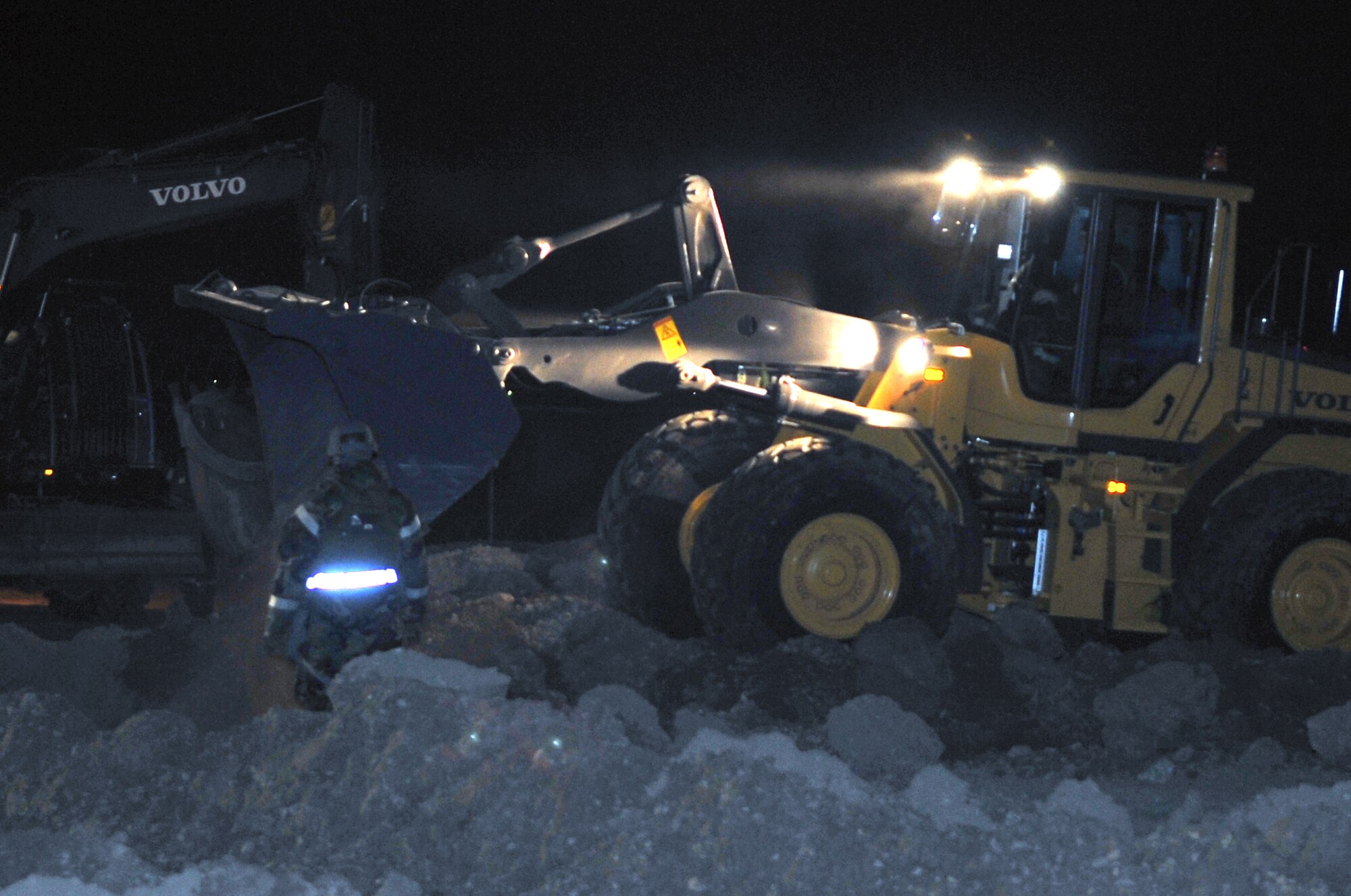 Members from the 51st Civil Engineer Squadron respond to a simulated crater in the runway. Their mission is to restore the flight line to mission ready operations, Jan. 31, 2012. The exercise is a peninsula-wide operational readiness exercise held to train U.S. forces throughout South Korea. (U.S. Air Force photo/Staff Sgt. Craig R. Cisek)