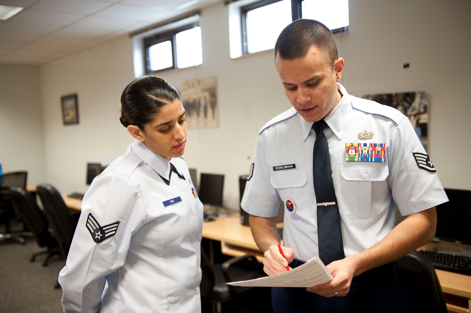 Staff Sgt. Kitsana Dounglomchan, airman leadership school instructor, gives feedback to Senior Airman Irna Diaz, 728th Air Mobility Squadron, after her presentation Jan. 30, 2012, at Incirlik Air Base, Turkey. ALS is a five-week course for senior airmen, and sometimes staff sergeants, to learn to be effective frontline supervisors.(U.S. Air Force photo by Senior Airman Clayton Lenhardt/Released)