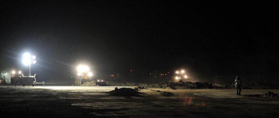 Members from the 51st Civil Engineer Squadron respond to a simulated crater in the runway. Their mission is to restore the flight line to mission ready operations, Jan. 31, 2012. The exercise is a peninsula-wide operational readiness exercise held to train U.S. forces throughout South Korea. (U.S. Air Force photo/Staff Sgt. Craig R. Cisek)