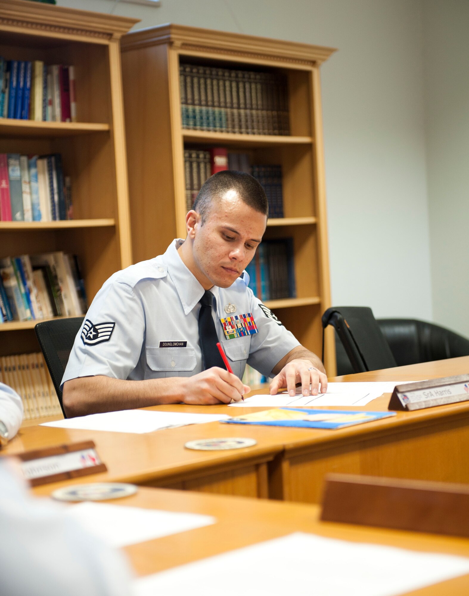 Staff Sgt. Kitsana Dounglomchan, airman leadership school instructor, takes notes during a student's presentation Jan. 30, 2012, at Incirlik Air Base, Turkey. ALS is a five-week course for senior airmen, and sometimes staff sergeants, to learn to be effective frontline supervisors.(U.S. Air Force photo by Senior Airman Clayton Lenhardt/Released)