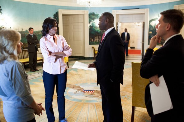 First lady Michelle Obama and Jill Biden are briefed by White House Fellow Lt. Col. Rodney Lewis Oct. 17, 2011, before a Joining Forces Initiative event in Washington. Lewis began his fellowship in August 2011 when he was assigned to the Office of the First Lady. (Official White House photo/Chuck Kennedy)