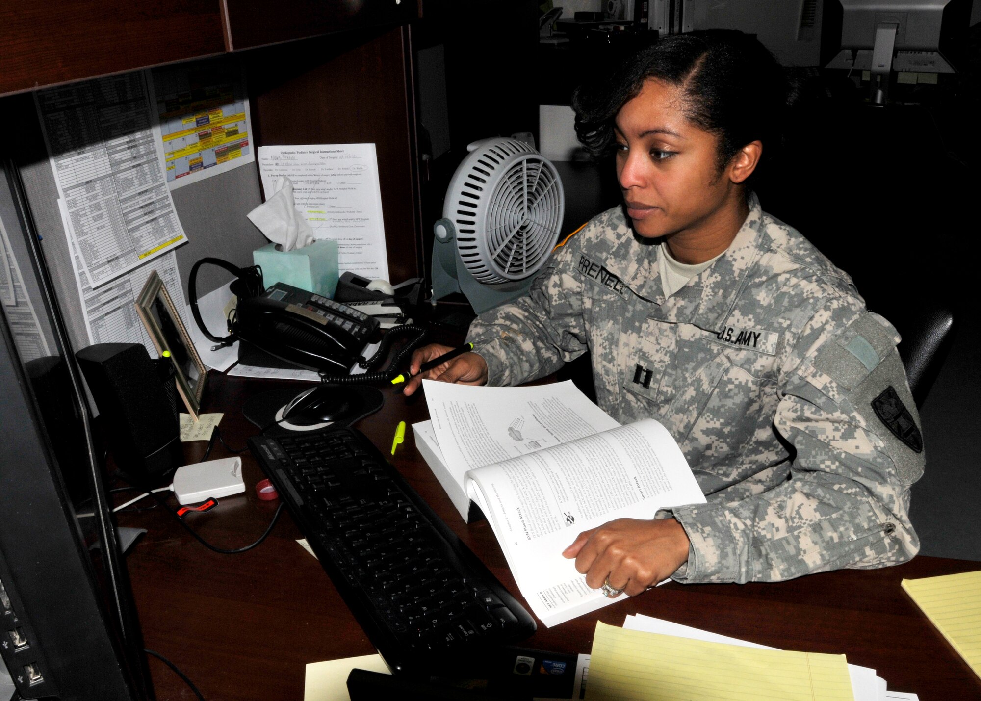 Captain Marni Prenell, 7th Sustainment Brigade communications officer closes out the duty day studying in her office for a network security exam the afternoon of Jan. 30. (U.S. Army photo by Sgt. 1st Class Kelly Jo Bridgwater/Released)