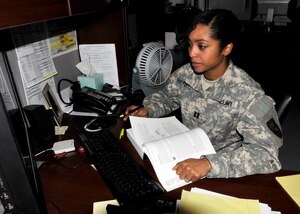 Captain Marni Prenell, 7th Sustainment Brigade communications officer closes out the duty day studying in her office for a network security exam the afternoon of Jan. 30. (U.S. Army photo by Sgt. 1st Class Kelly Jo Bridgwater/Released)