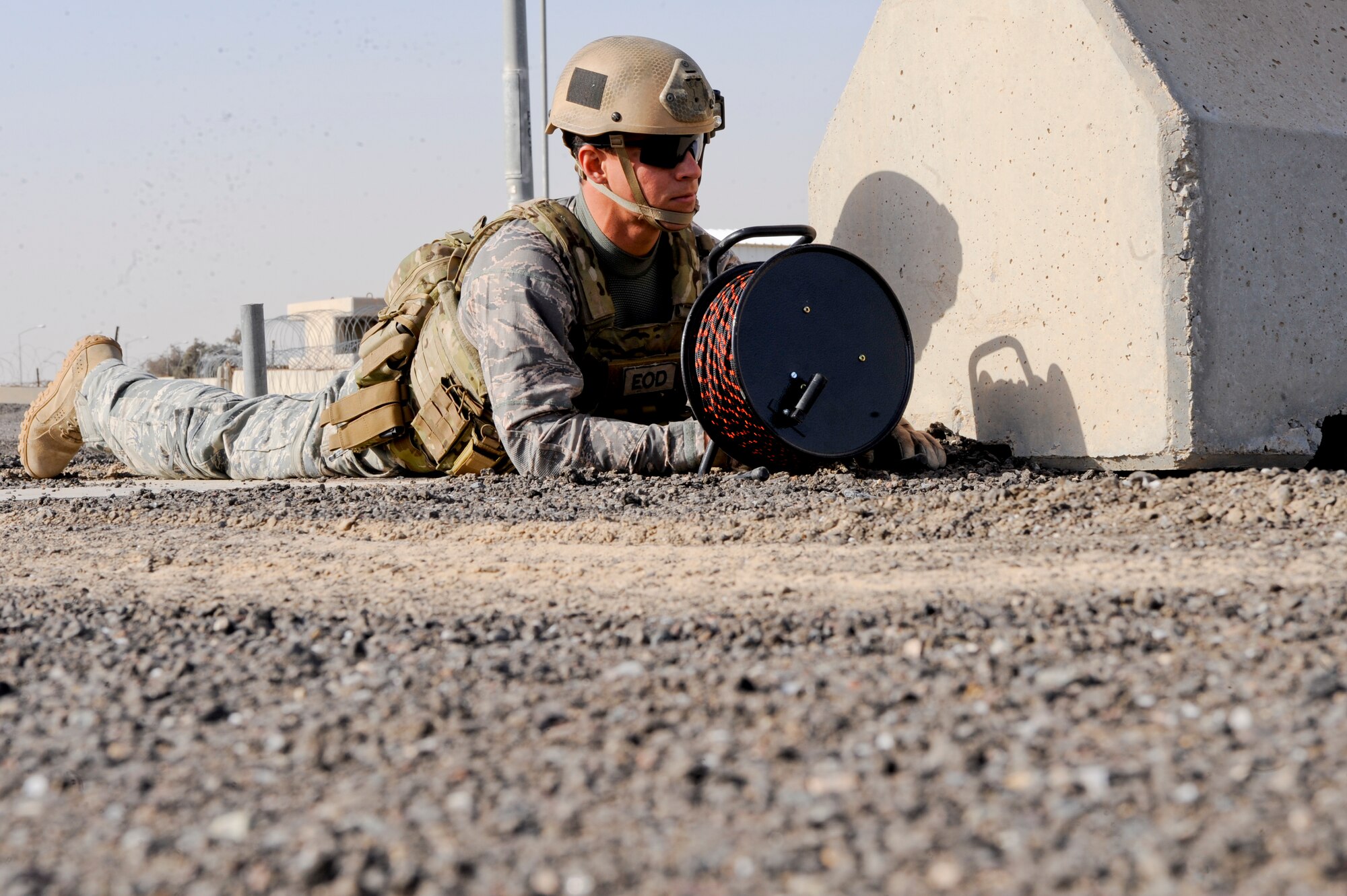 Staff Sgt. Matthew Childers, 332nd Expeditionary Civil Engineer Squadron explosive ordnance disposal flight, waits behind a barrier for a safe call prior to advancing to a bomb site during a mass casualty exercise at an undisclosed location in Southwest Asia, Jan. 30, 2012. EOD, fire department, medical and security forces personnel participated in the exercise. Childers is deployed from Dyess Air Force Base, Texas, and is a native of San Antonio, Texas. (U.S. Air Force photo by Staff Sgt. Joshua J. Garcia/Released)