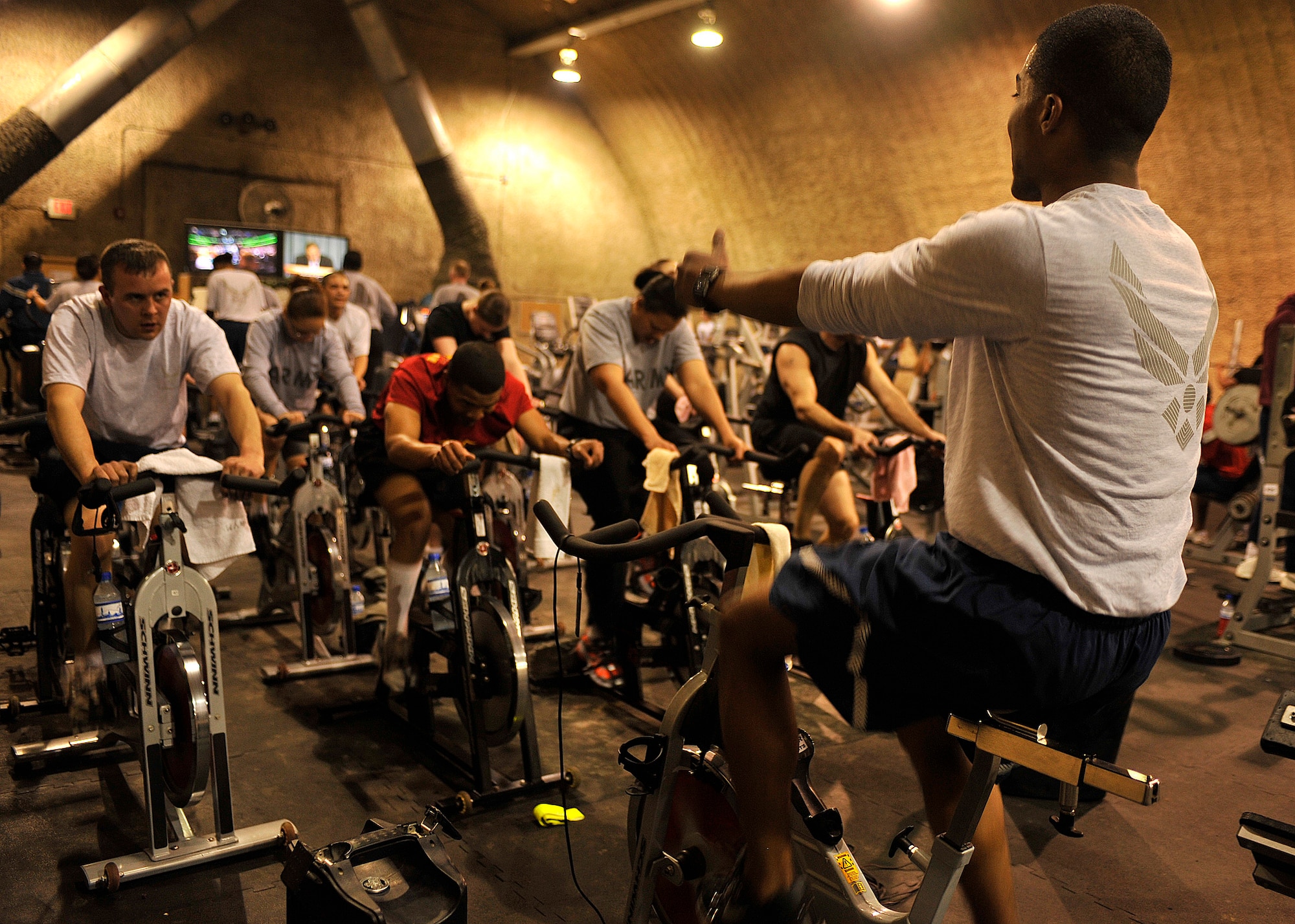 BAGRAM AIRFIELD, Afghanistan— Senior Airman Nicholas Gooden motivates his spin class through another sprint at Bagram Airfield, Afghanistan, Jan. 30, 2012. Gooden is a vehicle maintainer with the 455 Expeditionary Logistics Readiness Squadron and is deployed from Aviano Air Base, Italy. (U.S. Air Force photo/Airman 1st Class Ericka Engblom) 