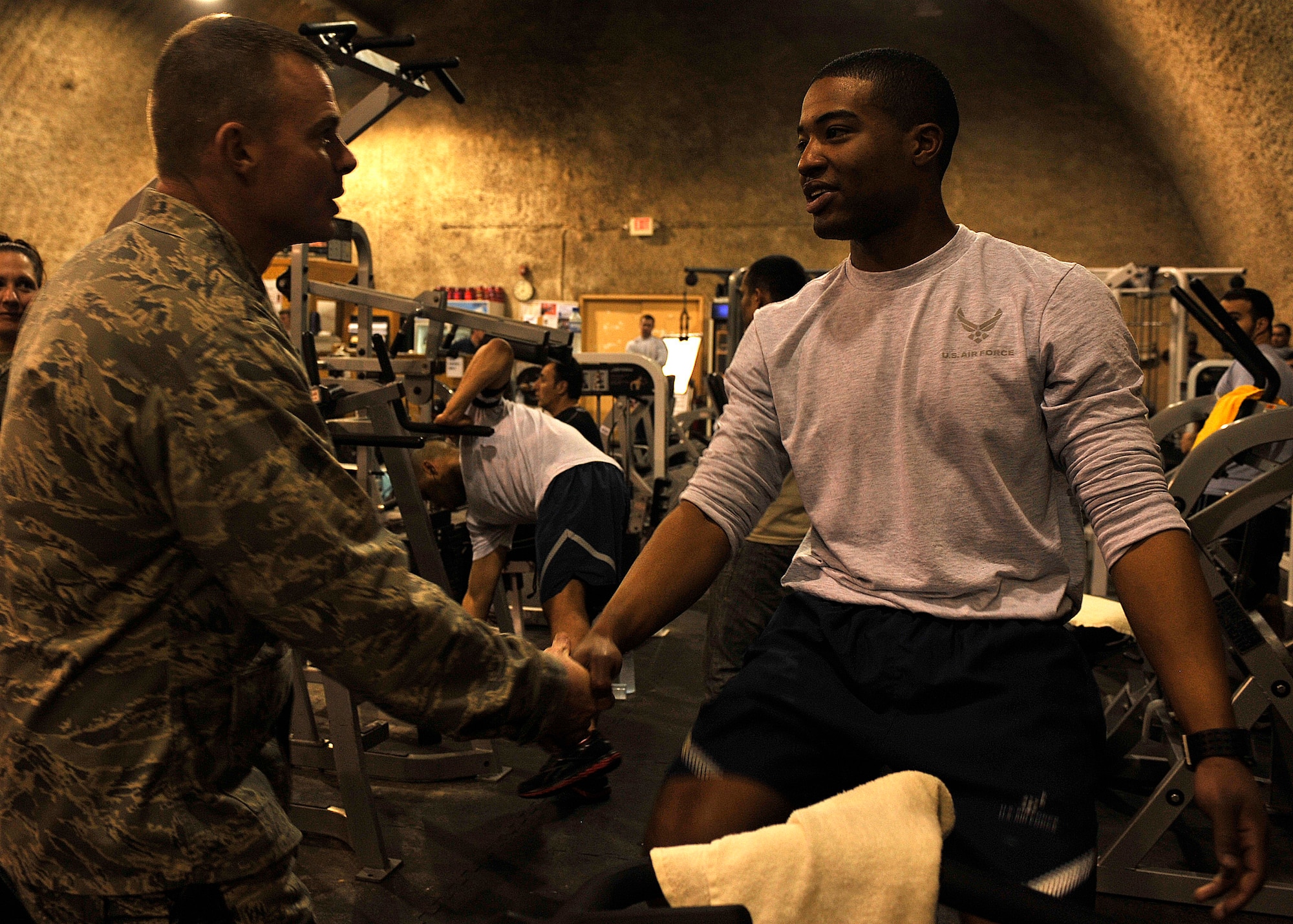 BAGRAM AIRFIELD, Afghanistan—Lt. Col. Thomas Forrester coins Senior Airman Nicholas Gooden at Bagram Airfield, Afghanistan, Jan. 30, 2012. Gooden is a vehicle maintainer with the 455 Expeditionary Logistics Readiness Squadron and is deployed from Aviano Air Base, Italy. He was recognized for his willingness to help his fellow Airmen. (U.S. Air Force photo/Airman 1st Class Ericka Engblom) 
