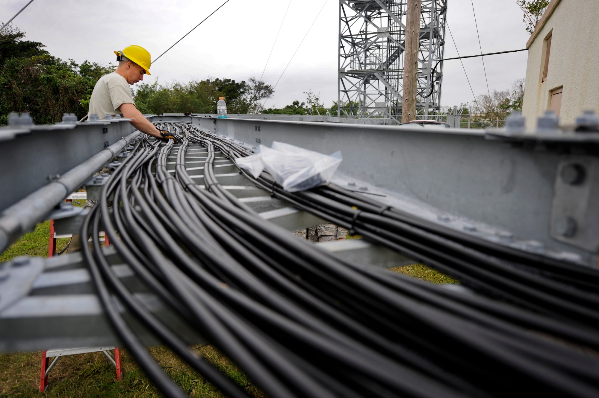 U.S. Air Force Airman 1st Class James Behr, 18th Communications Squadron cable and antenna systems technician, uses zip ties to organize circuits leading to an air-to-ground communication transmission tower on Kadena Air Base, Japan, Jan. 30. The tower is receiving numerous upgrades totaling nearly $800,000 to improve Kadena's flightline capabilities. (U.S. Air Force photo by Airman 1st Class Maeson L. Elleman/Released)