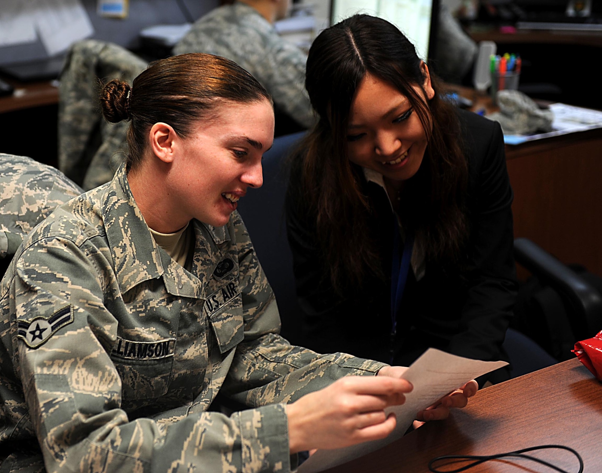 U.S. Air Force Airman 1st Class Tara Williamson, 18th Wing Public Affairs photojournalist, reviews interview questions with Japanese intern Yuka Higa, a student at Nikkei College of Business on Kadena Air Base, Japan, Jan. 25, 2012. Higa participated in an internship and shadow program at Kadena to experience working in an English-speaking environment before going to a home-stay program in the United States in February. (U.S. Air Force photo by Airman 1st Class Brooke P. Beers/Released) 