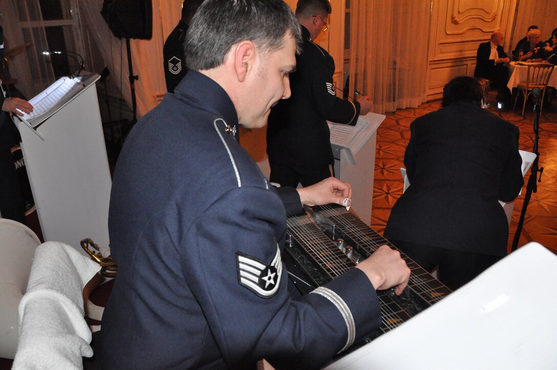 SSGT Tim Rogers plays the pedal steel guitar  and exposes the audience to some American country music sounds