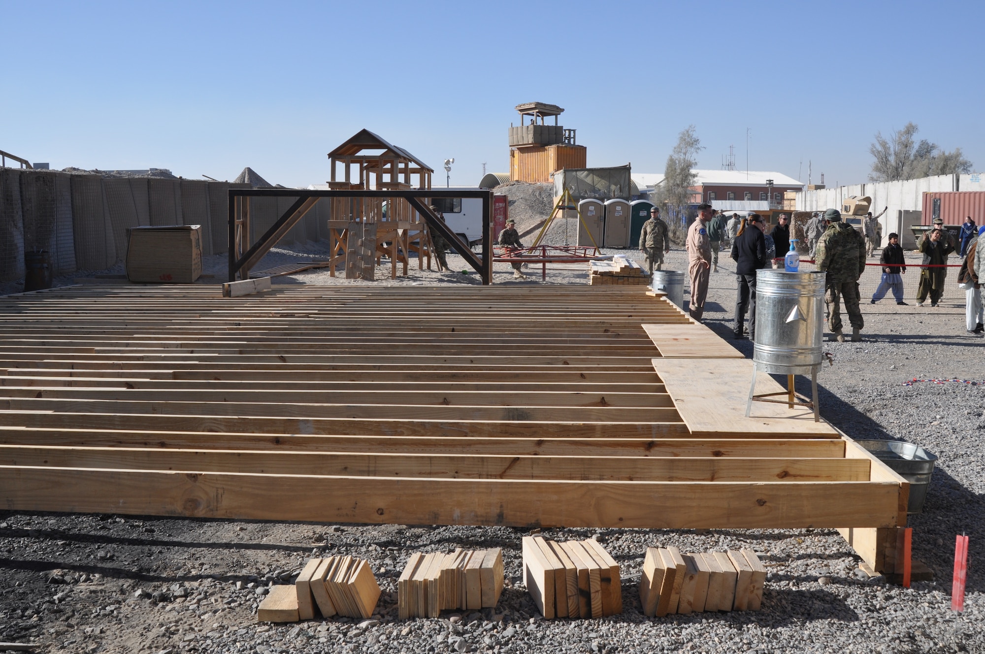 KANDAHAR AIRFIELD, Afghanistan -- Blocks of wood donated by the departing Canadian forces become the foundation of the new bazaar school. Volunteers from the 809th Expeditionary RED HORSE Squadron, 30th Naval Construction Regiment and 422nd Expeditionary Signal Battalion rebuilt the school that reopened Jan. 21, 2012. (U.S. Air Force photo by Capt. Passion Julinsey)