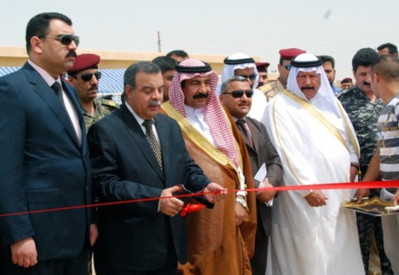 IRAQ -- Government officials and representatives from Iraq's Ministry of Municipalities and Public Works cut the ribbon at a ceremony celebrating the facility's completion.