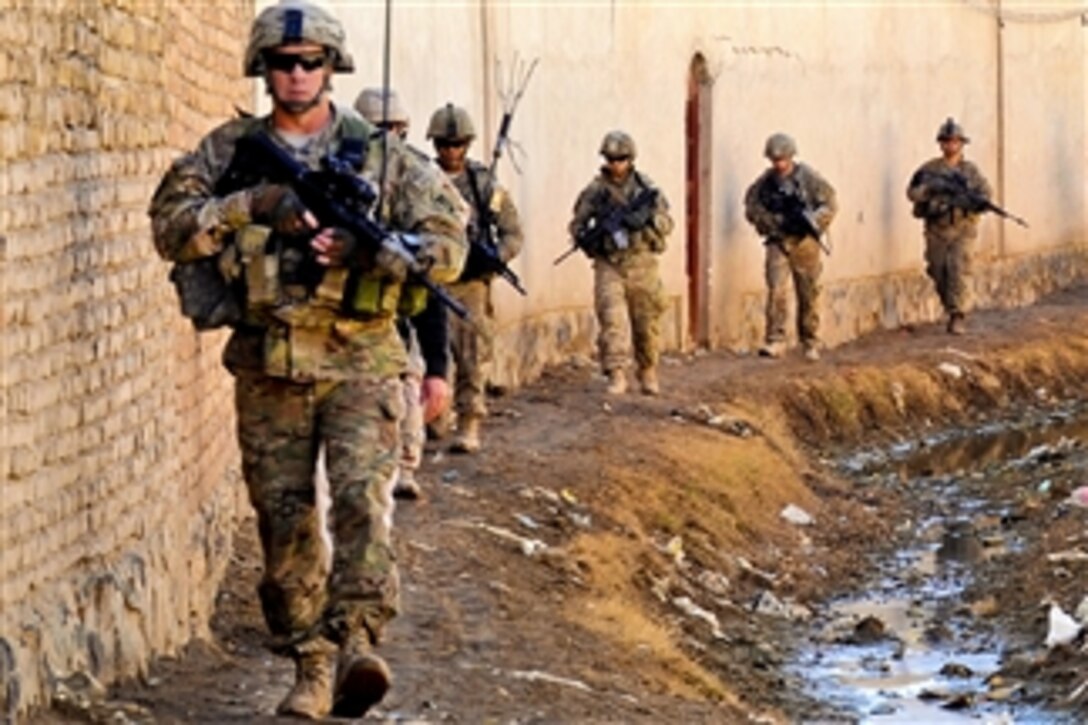 U.S. troops walk to the Department of Public Works facility and a water distribution point to inspect a project in Kandahar province, Afghanistan, on Jan. 28, 2012.  The troops are assigned to the Kandahar Provincial Reconstruction Team.  The project is set to be complete in two weeks.  