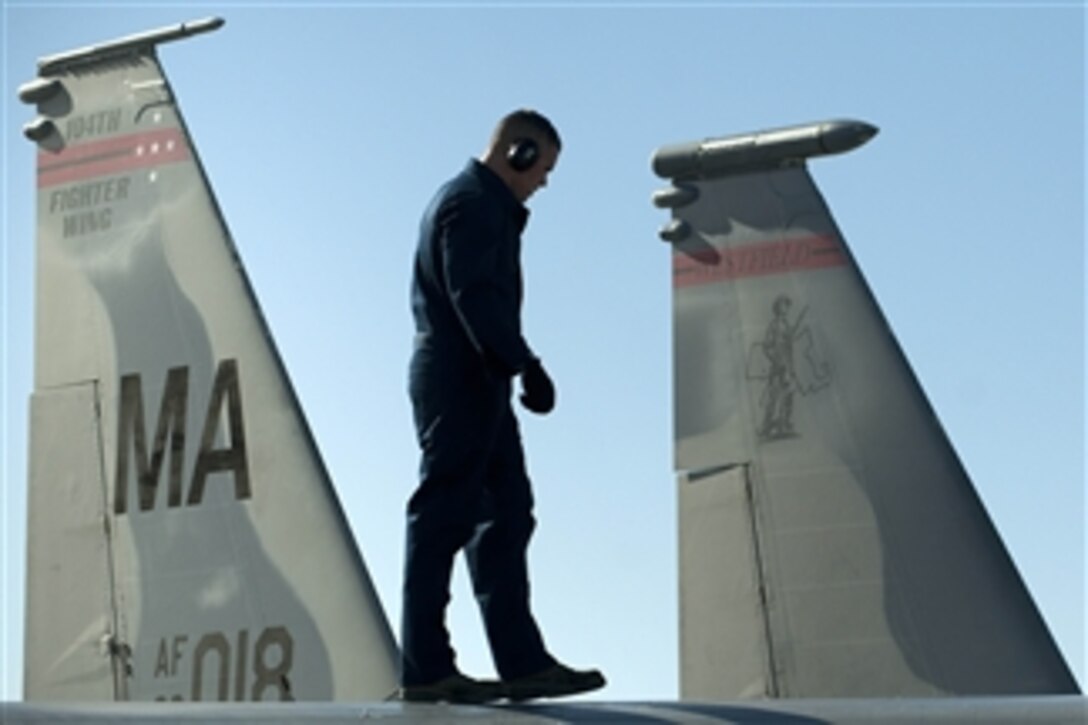 U.S. Air Force Tech. Sgt. Aaron Richards, with the 104th Fighter Wing, Massachusetts Air National Guard, inspects the top of an F-15E Strike Eagle aircraft during Red Flag at Nellis Air Force Base, Nev., on Jan. 27, 2012.  Red Flag is an advanced aerial combat training exercise held four to six times a year to train pilots from the U.S., NATO and other allied countries in real combat situations.  
