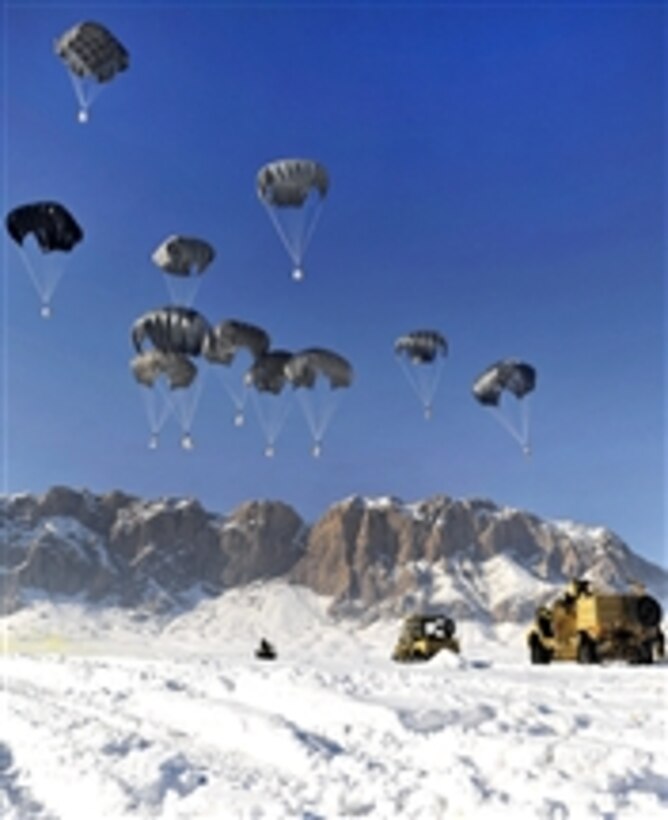 Members of coalition special operations forces wait to recover supplies during an airdrop in the Shah Joy district in Afghanistan's Zabul province on Jan. 25, 2012.  