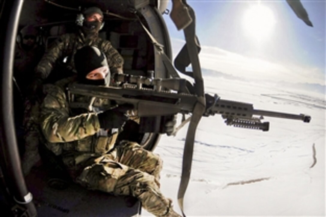 U.S. Army Cpl. William Hopkins looks through the scope of a Barrett .50-Cal. while Army Sgt. Lucas Cordes waits for the UH-60 Black Hawk helicopter to turn around so they can begin an aerial firing exercise over Logar province, Afghanistan, Jan. 26, 2012. Hopkins is a spotter and Cordes is a sniper team leader assigned to the 82nd Infantry Division's Company F, 2nd Aviation Assault Battalion, 82nd Combat Aviation Brigade.