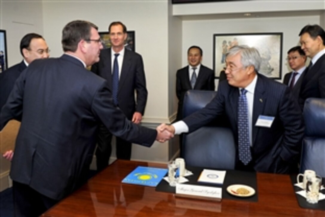 Deputy Defense Secretary Ashton B. Carter shakes hands with Erian Idrissov, Kazakhstan's ambassador to the United States, as he welcomes Kazakhstan's Foreign Affairs Minister Yerzhan Kh. Kazykhanov, far left, to the Pentagon, Jan. 31, 2012.