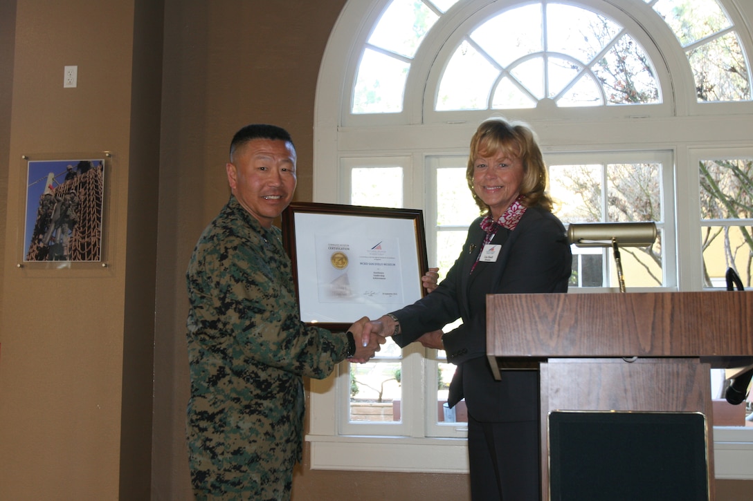 Marine Corps Recruit Depot San Diego Commanding General Brig. Gen. Daniel D. Yoo, is awarded the first Marine Corps museum re-certification by Lin Ezell, National Museum of the Marine Corps director, Jan. 31 aboard MCRD San Diego's Command Museum. MCRD was orginally certified in 1987 by the Marine Corps history department. Now under the new Marine Administrative Message that came out in 2005 the four certified Marine museums are required to get re-certified every ten years by the National Museum of the Marine Corps, said Ezell. In late 2010 members of the National Museum of the Marine Corps came to MCRD to evaluate the museum staff, records and more. They concluded that the museum was well supported by the command and eligible for re-certification "As I tell the recruit families, this museum is a window into the soul of our corps," said Yoo. "For us to be able to show everyone that comes through, our espirt de corps, its pretty significant."