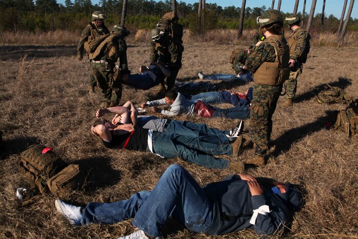 Marines and Sailors with Combat Logistics Battalion 24, 24th Marine Expeditionary Unit and Charlie Company, Battalion Landing Team 1st Battalion, 2nd Marine Regiment, 24th MEU, deliver a simulated casualty on a stretcher to a triage area during a mass casualty exercise at Oak Grove Outlying Airfield, Jan. 31. The 24th MEU deployed a Rapid Response Medical Team from the USS Gunston Hall off the coast of North Carolina during the exercise to provide emergency medical attention to around 30 simulated casualties. The 24th MEU is conducting their Certification Exercise (CERTEX) with Amphibious Squadron 8 scheduled Jan. 27 to Feb. 17, which includes a series of missions intended to evaluate and certify the unit for their upcoming deployment.