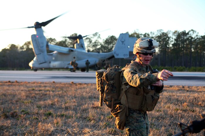 Cpl. Adam Swanson, a team leader with 3rd Platoon, Charlie Company, Battalion Landing Team 1st Battalion, 24th Marine Expeditionary Unit, guides his Marines onto an MV22 Osprey while extracting at the conclusion of a mass casualty exercise at Oak Grove Outlying Airfield, Jan. 31. The 24th MEU deployed a Rapid Response Medical Team from the USS Gunston Hall off the coast of North Carolina during the exercise to provide emergency medical attention to around 30 simulated casualties. The 24th MEU is conducting their Certification Exercise (CERTEX) with Amphibious Squadron 8 scheduled Jan. 27 to Feb. 17, which includes a series of missions intended to evaluate and certify the unit for their upcoming deployment.