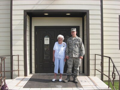 Virginia Stafford and Tech. Sgt. Dustin Martin, 502nd Air Base Wing Chaplain Corps, stand in front of the historic Airman Memorial Chapel April 15. (U.S. Air Force photo)