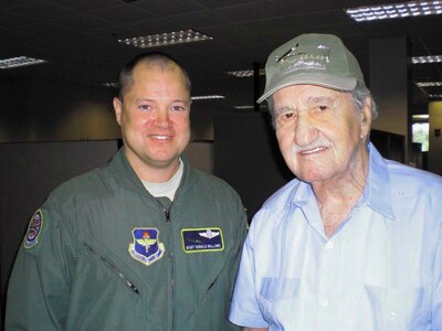 Master Sgt. Donald Ballowe, recipient of two Distinguished Flying Crosses with Valor for his actions in Afghanistan, and World War II veteran Ken Ganther, a U.S. Army Air Corps flight engineer who participated in the D-Day invasion, meet at the 344th Training Squadron June 8. (U.S. Air Force photo)