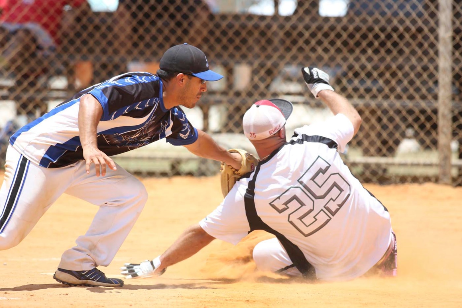 Warhawks catcher Daniel Ayon tags a Fort Bliss player out at home plate Sunday during a loser’s bracket game against Fort Bliss. The Warhawks defeated Fort Bliss 19-13, and went on to win the Commander’s Cup tournament title. (U.S. Air Force photo/Robbin Cresswell)