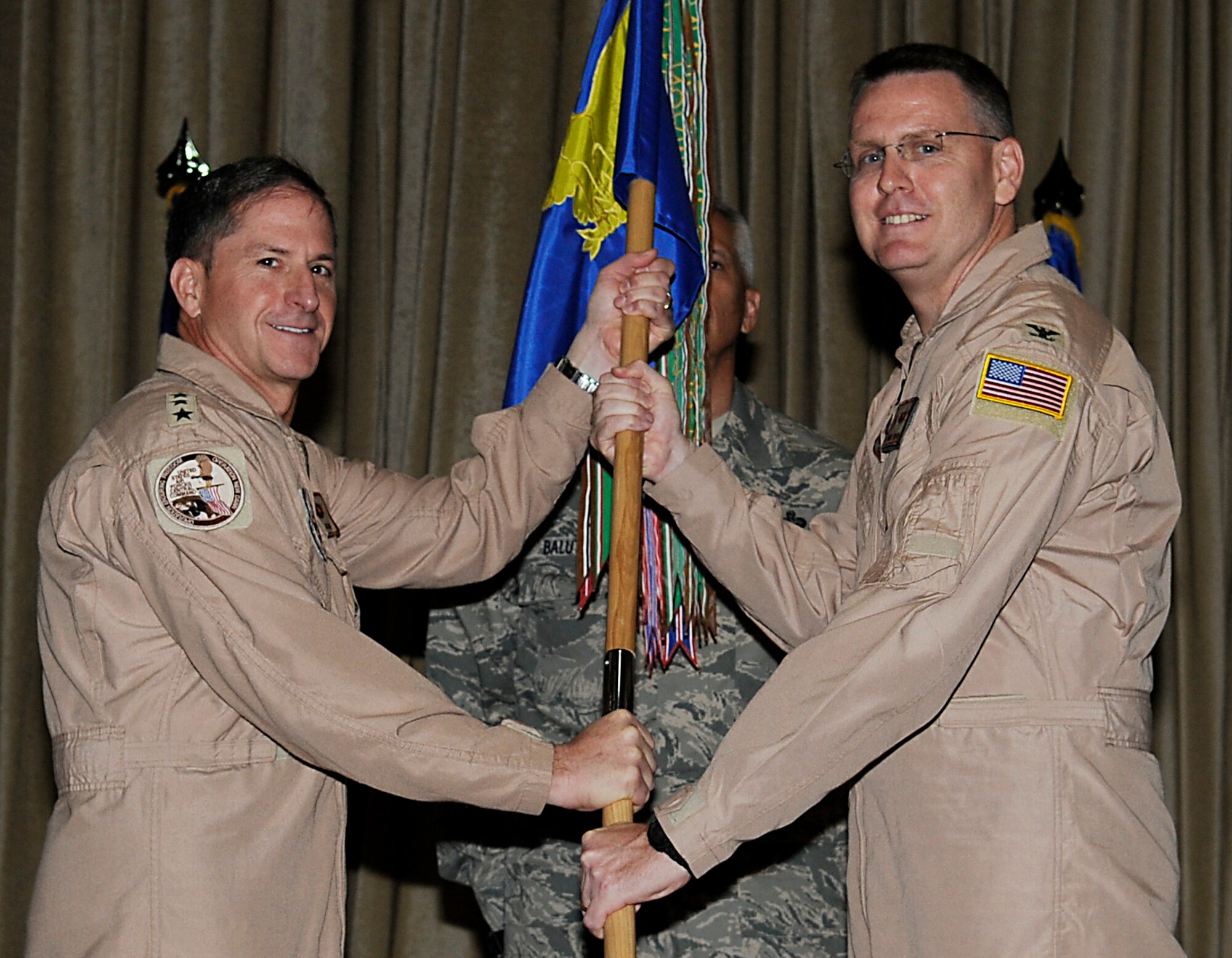 SOUTHWEST ASIA - Lieutenant Gen. Mark Goldfein, Commander, U. S. Air Forces Central, hands the 386th Air Expeditionary Wing guidon to Col. David Farrow  during a change of command ceremony here July 1, 2012. (U.S. Air Force photo/Staff Sgt. Alexandra Boutte)
